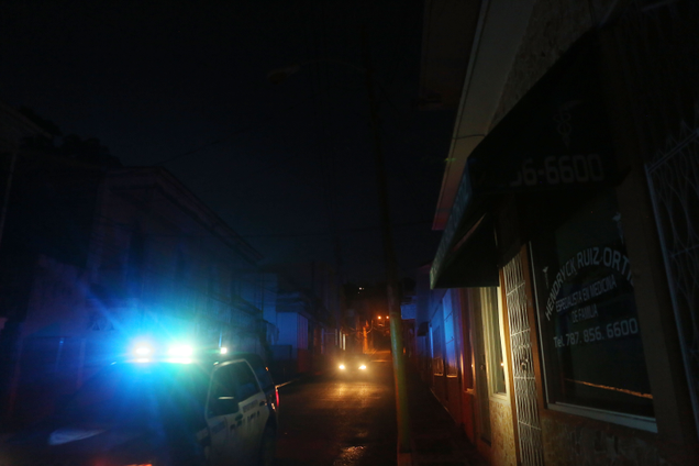 A police car patrols in an area with a sporadic electricity supply, as a nightly curfew remains in effect, on October 14, 2017, in Yauco, Puerto Rico. Photo: Getty